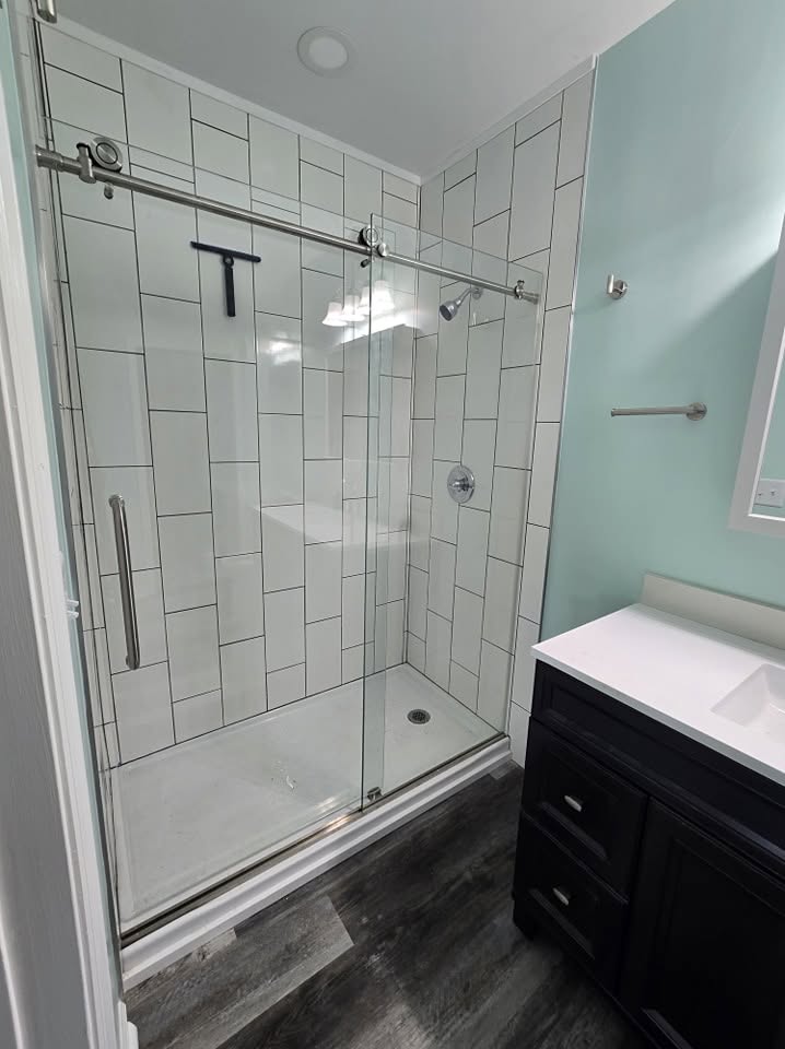 White tiled shower with sliding glass doors