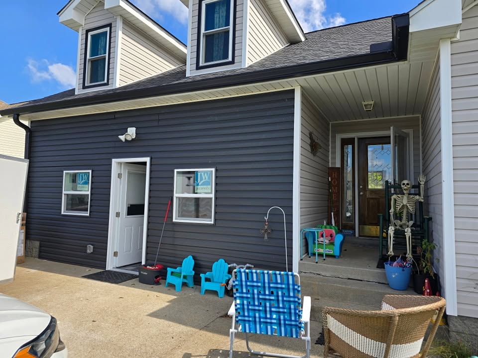 House exterior with navy siding and white trim