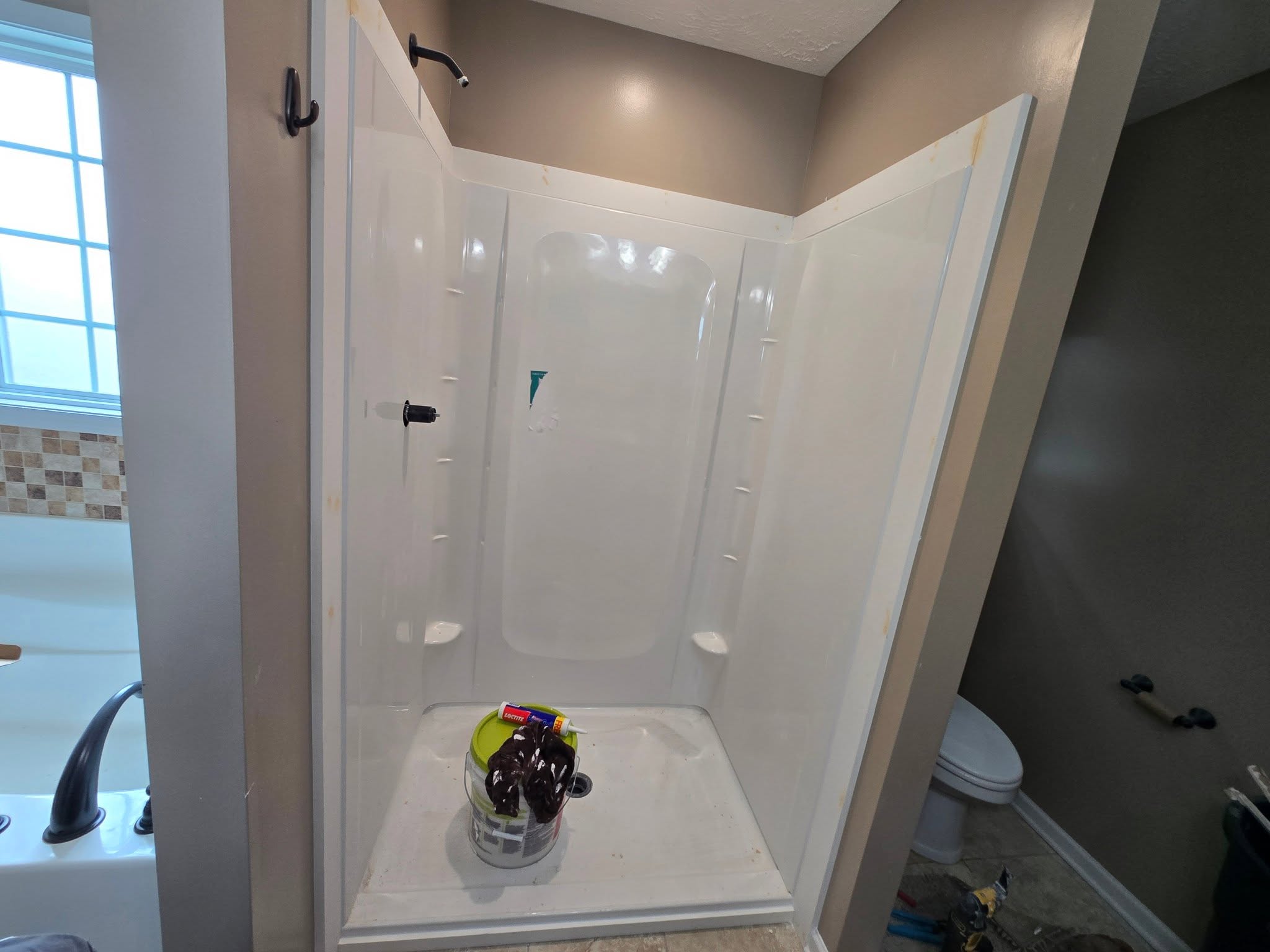 White shower stall during an upgrade project